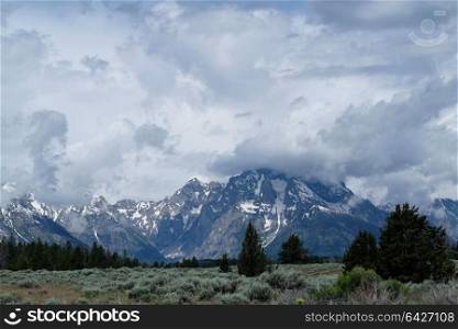 Grand Teton Mountains with low clouds. Grand Teton National Park, Wyoming, USA.