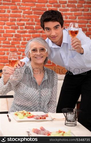Grandchildren and grandparents toasting with wine