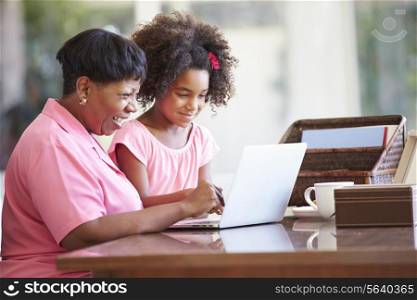 Granddaughter Helping Grandmother With Laptop
