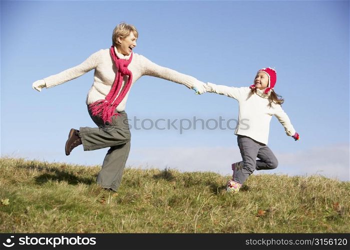 Granddaughter Running And Pulling Grandmother By The Hand