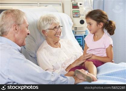 Granddaughter Visiting Grandmother In Hospital Bed