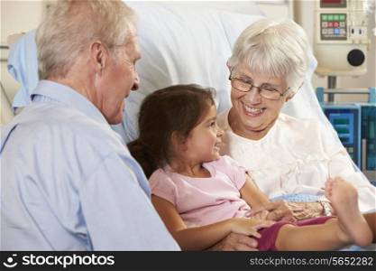 Granddaughter Visiting Grandmother In Hospital Bed