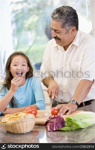 Grandfather And Granddaughter Preparing meal,mealtime Together