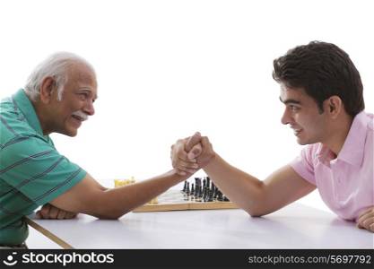 Grandfather and grandson doing arm wrestling