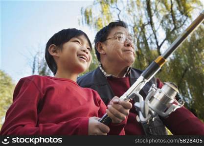 Grandfather and grandson fishing portrait