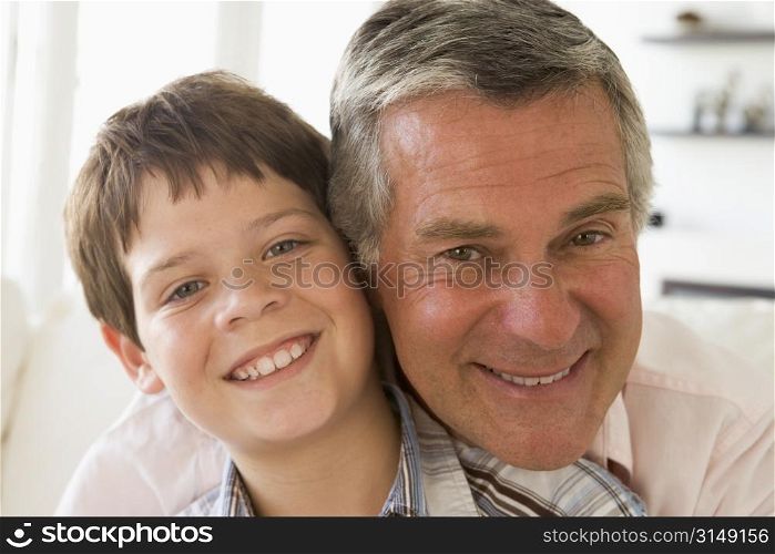 Grandfather and grandson indoors smiling