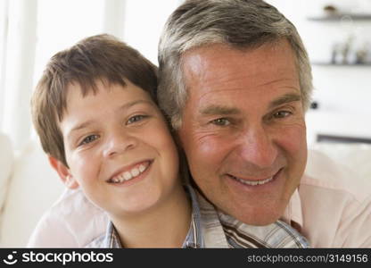 Grandfather and grandson indoors smiling