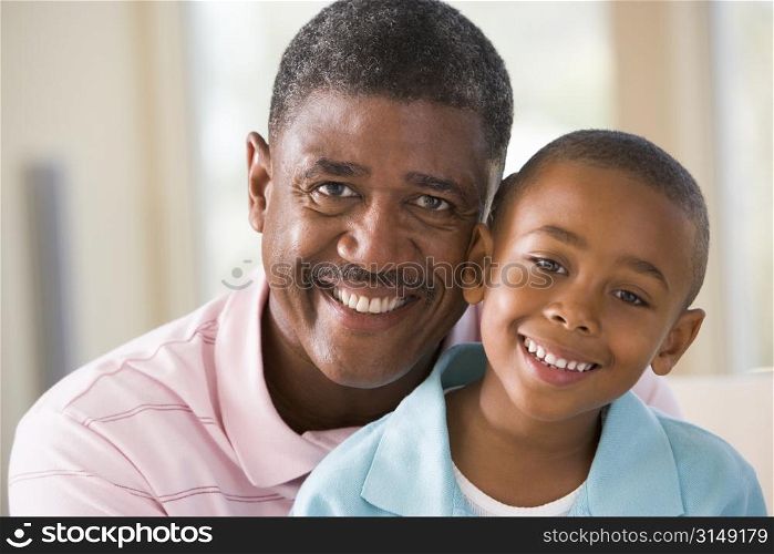 Grandfather and grandson indoors smiling
