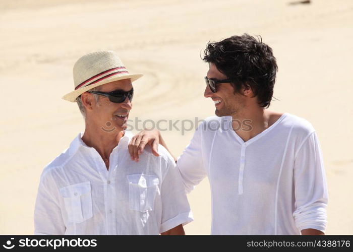 Grandfather and grandson on the beach