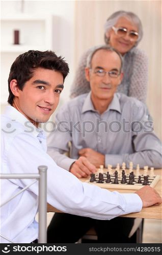 Grandfather and grandson playing chess