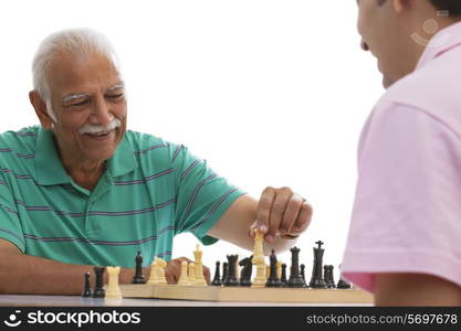 Grandfather and grandson playing chess