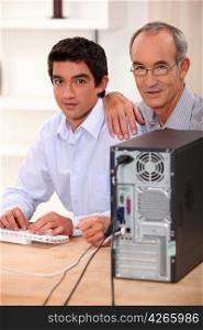 Grandfather and grandson with computer
