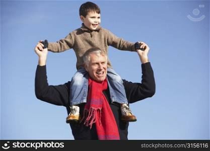 Grandfather Carrying Grandson On His Shoulders