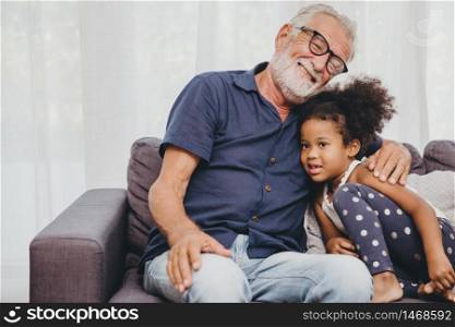 Grandfather embraces hug love for the little girl niece in a warm family home.
