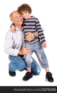 Grandfather embracing his grandson, indoors against white background..