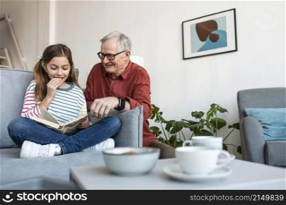 grandfather girl reading together