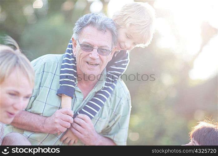 Grandfather giving grandson piggy back