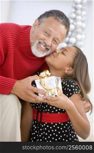 Grandfather Giving His Granddaughter A Christmas Present
