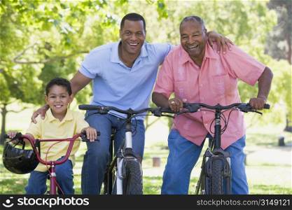 Grandfather grandson and son bike riding.