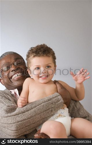 Grandfather holding baby boy