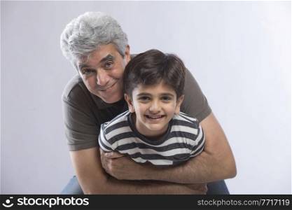 Grandfather hugging his grandson