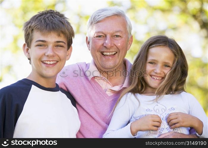 Grandfather laughing with grandchildren.