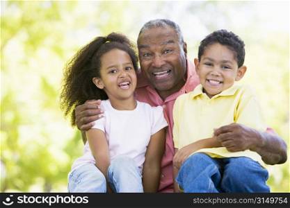 Grandfather laughing with grandchildren.