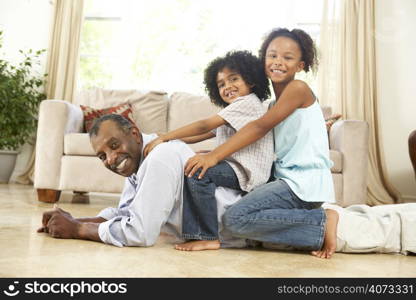 Grandfather Playing With Grandchildren At Home