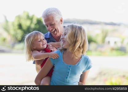 Grandfather playing with granddaughters