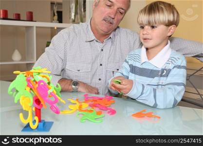 grandfather playing with grandson