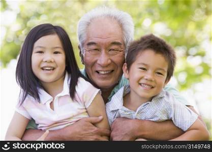 Grandfather posing with grandchildren.