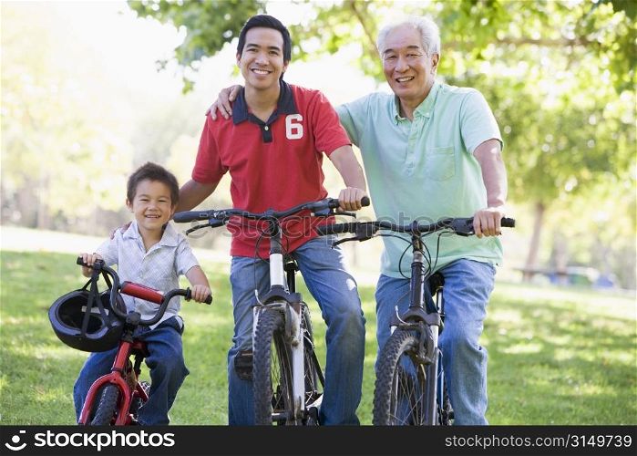 Grandfather son and grandson bike riding.