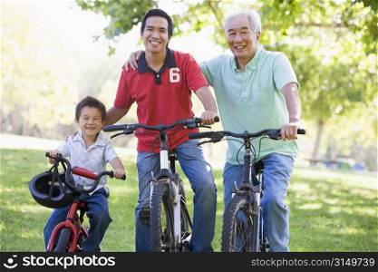 Grandfather son and grandson bike riding.