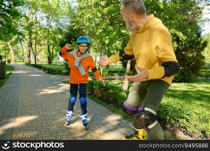 Grandfather teaching grandson riding roller skates in city park. Happy family enjoying fun time and active sport recreation outdoors. Grandfather teaching grandson riding roller skates in city park