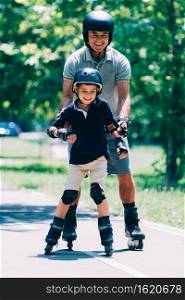 Grandfather teaching grandson roller skating in the park