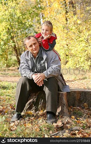 grandfather with child in autumn park