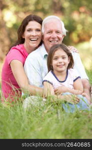 Grandfather With Daughter And Granddaughter In Park