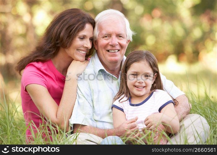 Grandfather With Daughter And Granddaughter In Park