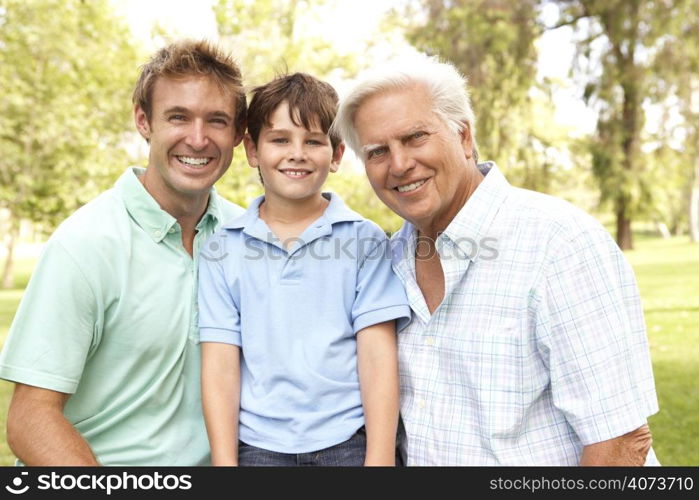 Grandfather With Father And Son In Park