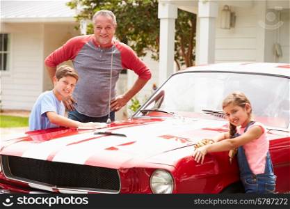 Grandfather With Grandchildren Cleaning Restored Classic Car