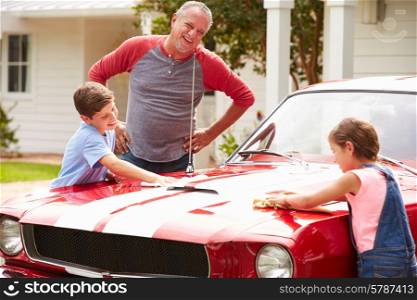 Grandfather With Grandchildren Cleaning Restored Classic Car