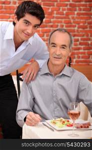 Grandfather with grandson at restaurant