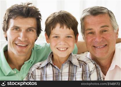 Grandfather with son and grandson smiling.