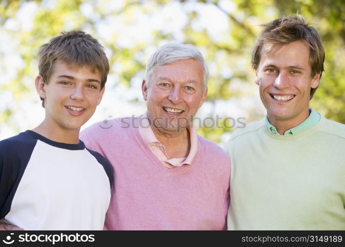 Grandfather with son and grandson smiling.