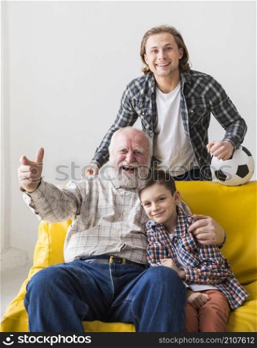 grandfather with son grandson watching game
