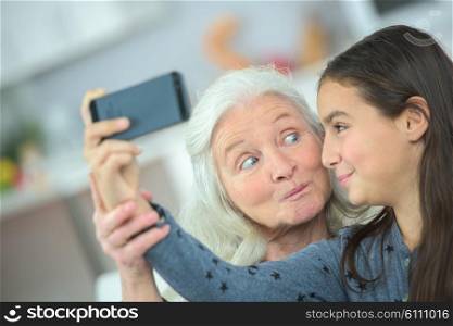 Grandma and girl taking a photo of themselves