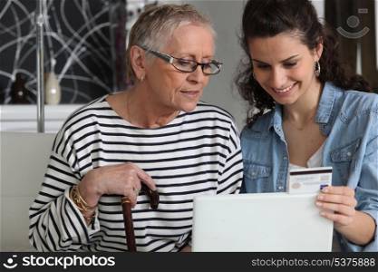 grandma and home helper with laptop