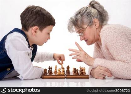 Grandma and nephew face to face playing chess