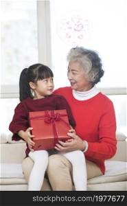 Grandma giveing her granddaughter a New Year gift