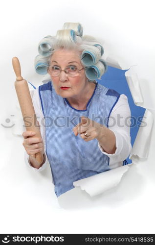grandma with hair curlers threatening someone with rolling pin